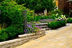 Landscaped garden with stone landscaping and interlocking feature