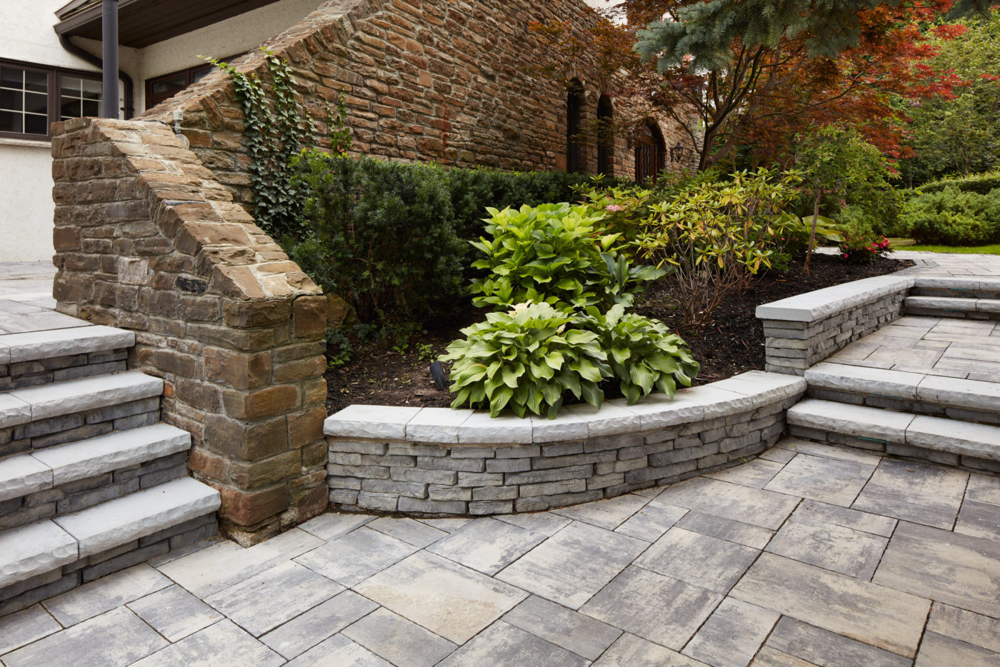 Intricater stone work with raised garden bed. Create a clear pathway through this property.