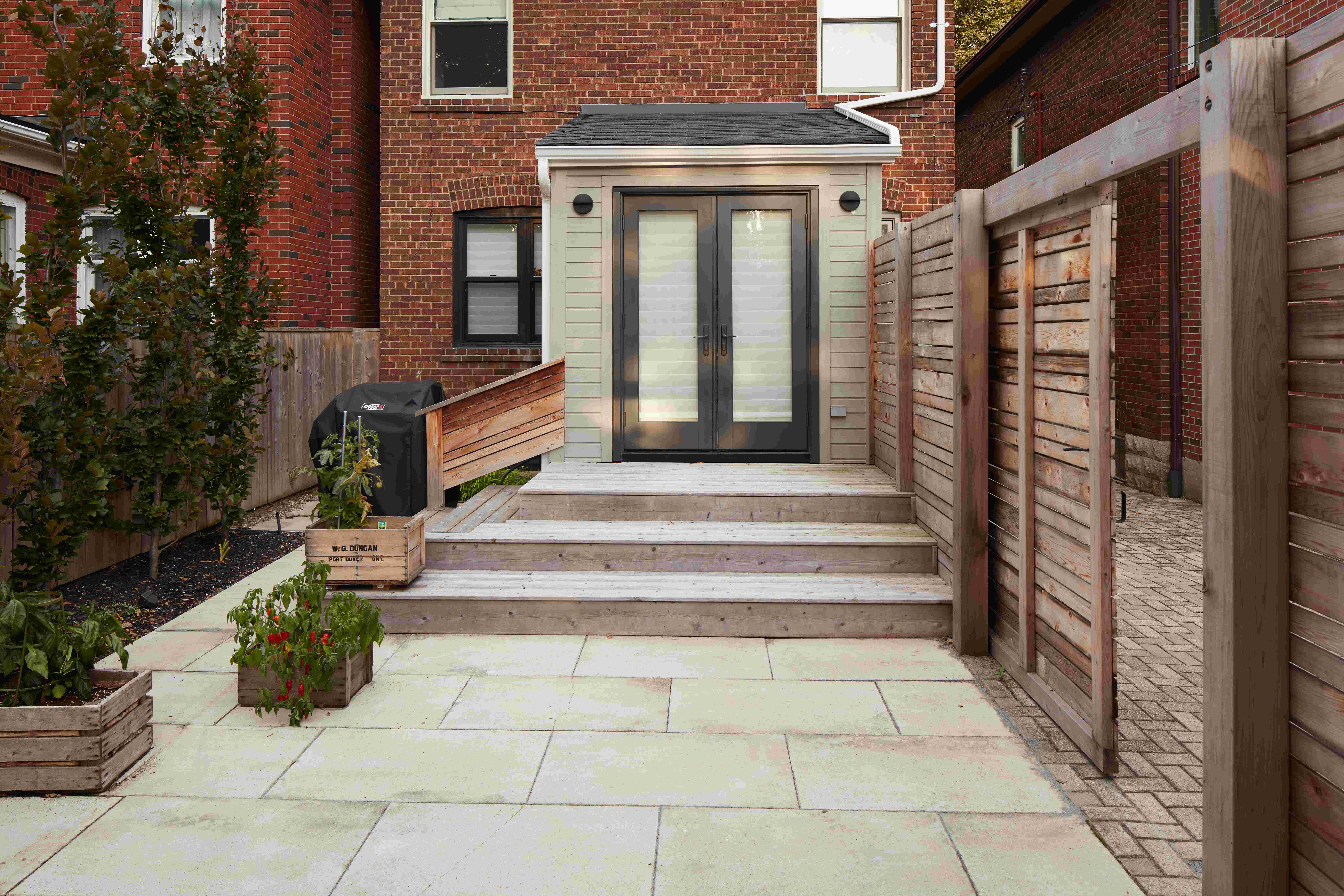 Stone Steps leading up to backdoor. Stonework and vegetable boxes on display