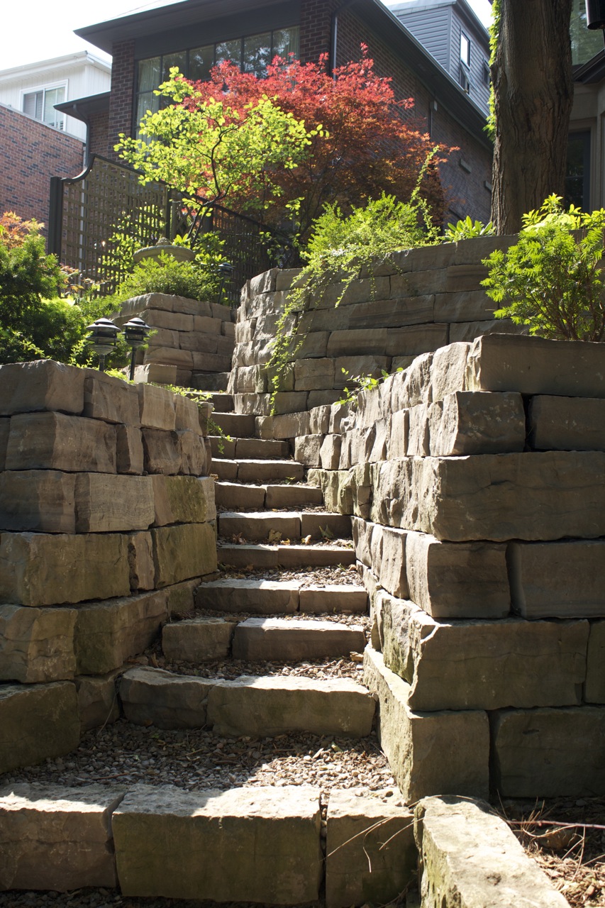 Stone Stairwell leading up stairs built into natural hillside in downtown toronto