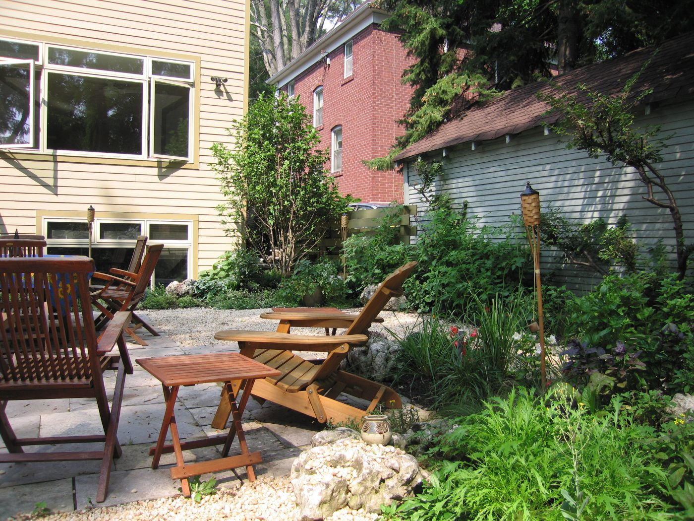outdoor seating area around natural stylized garden beds