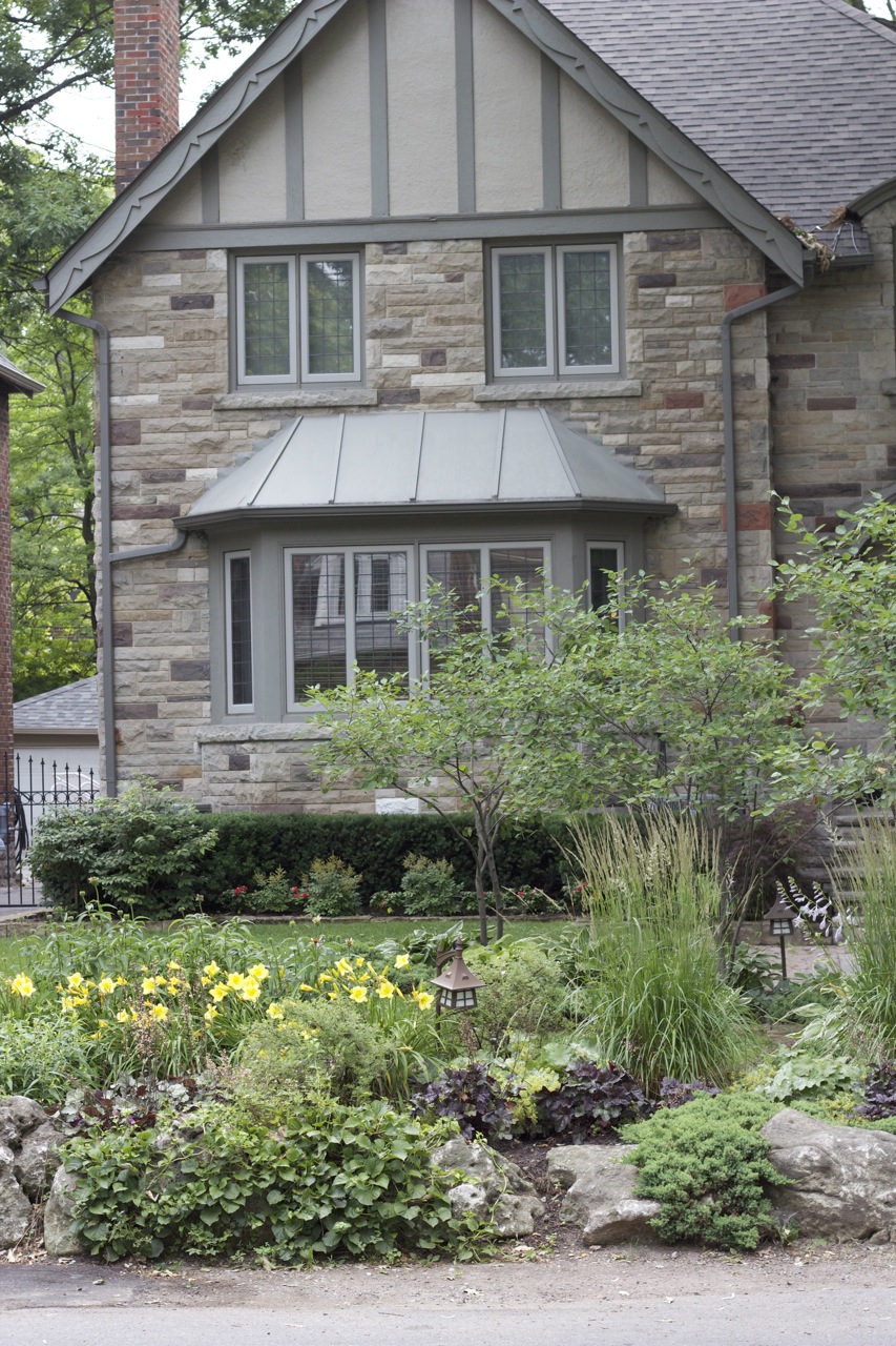 Front angle of the house showcasing natural gardens