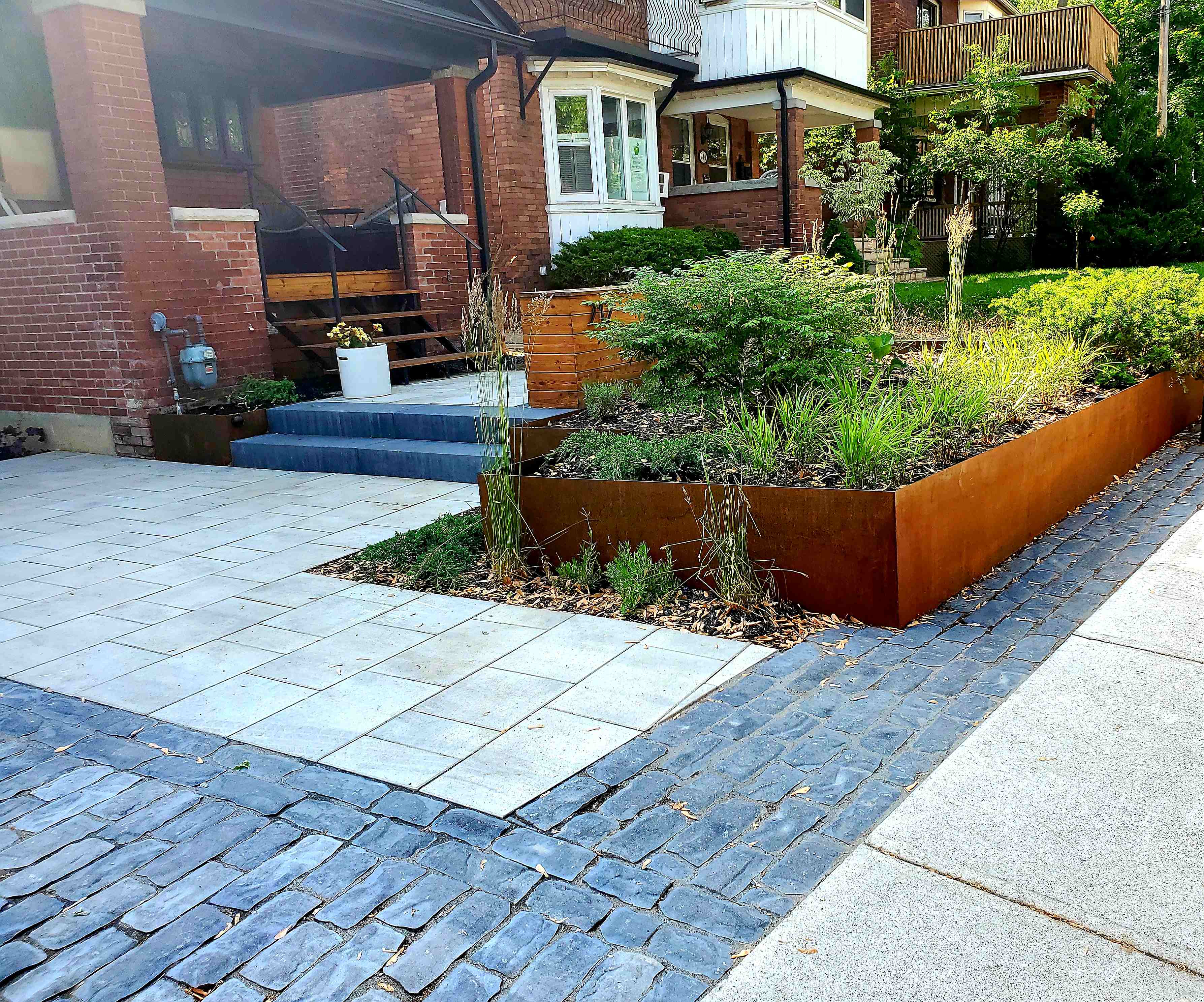 interlock driveway next to copper planter