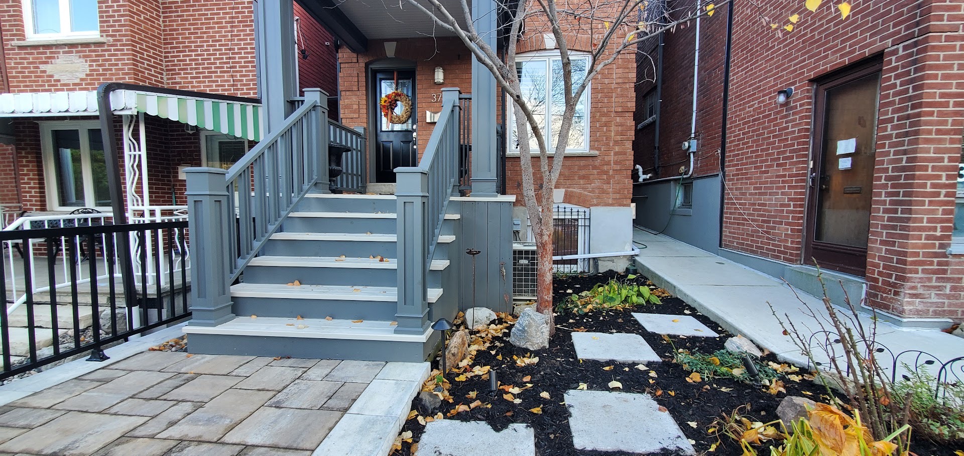 garden bed with stepping's stones and iron railing
