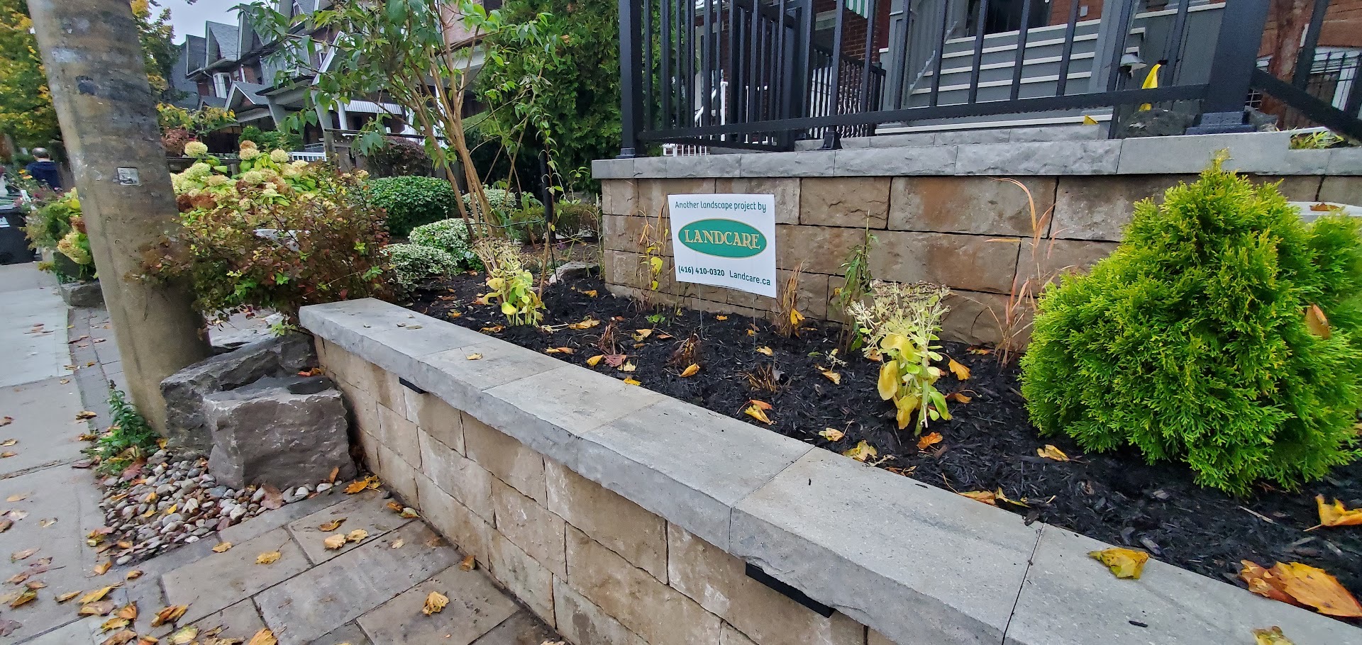 Retaining Wall with Perennials and Landcare Sign