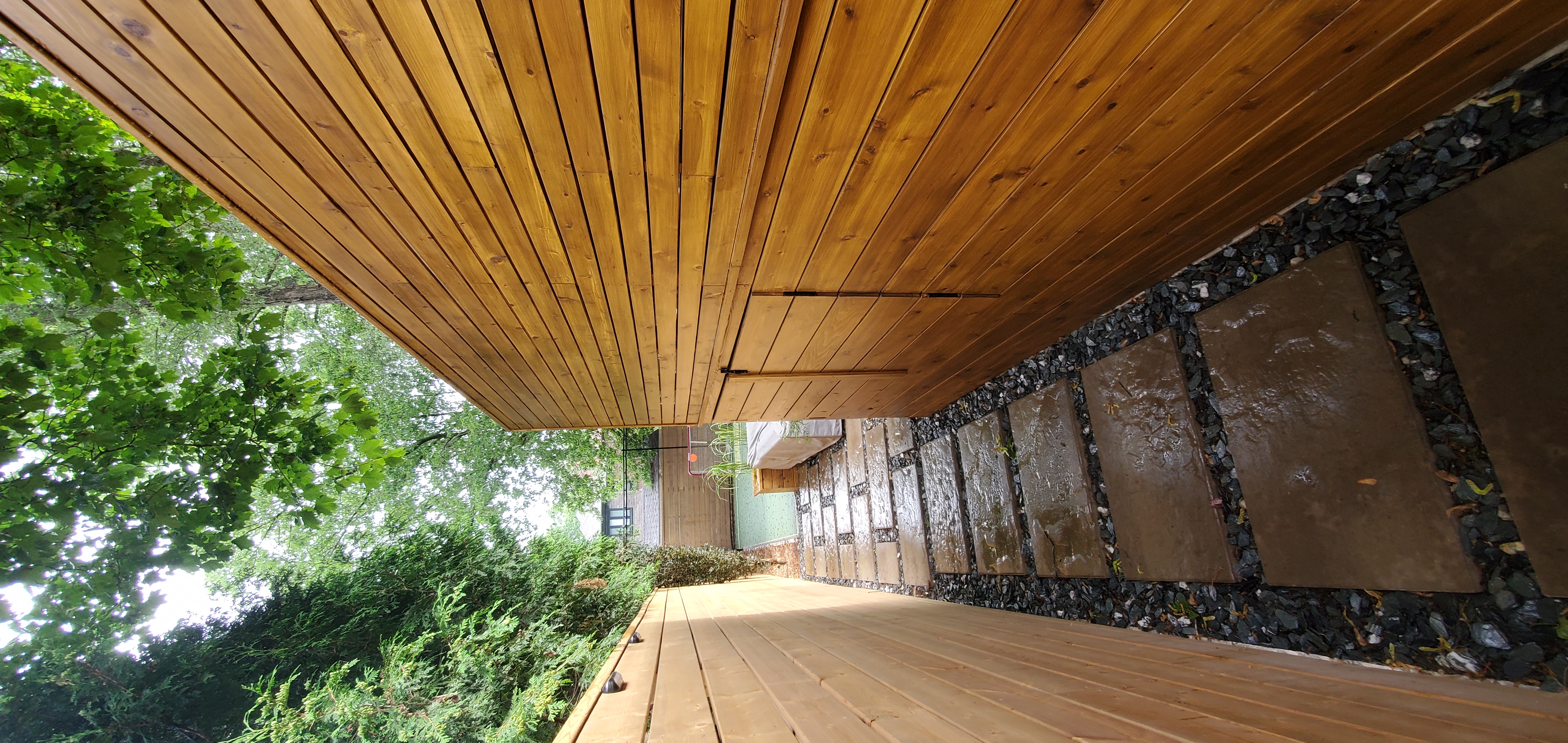 walkway to the backyard with concrete stone slabs guiding the way