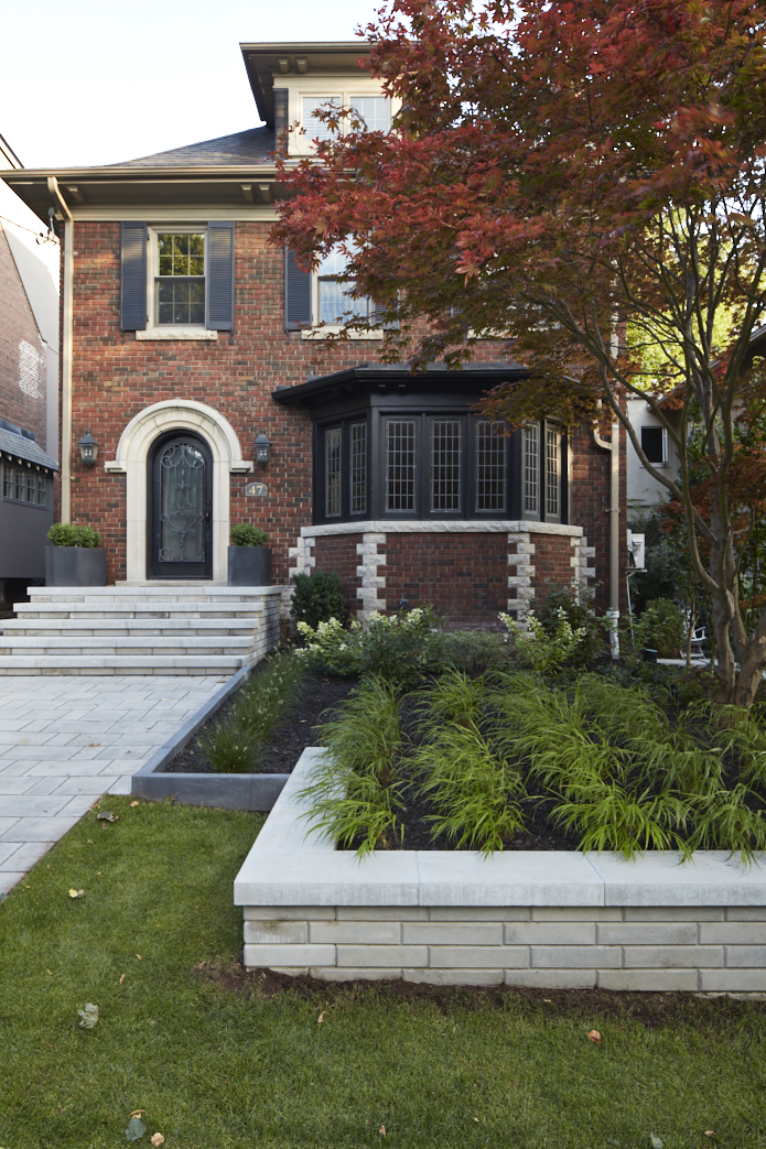 Granite retaining wall creates luxurious low maintenance garden beds