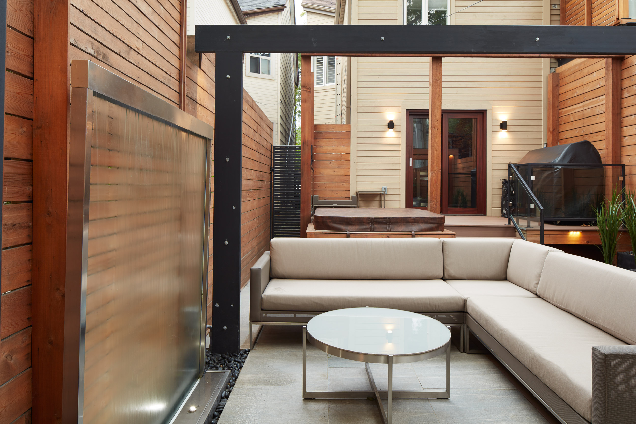 Perfect outdoor cocktail area. Outdoor seating with a table and water feature.