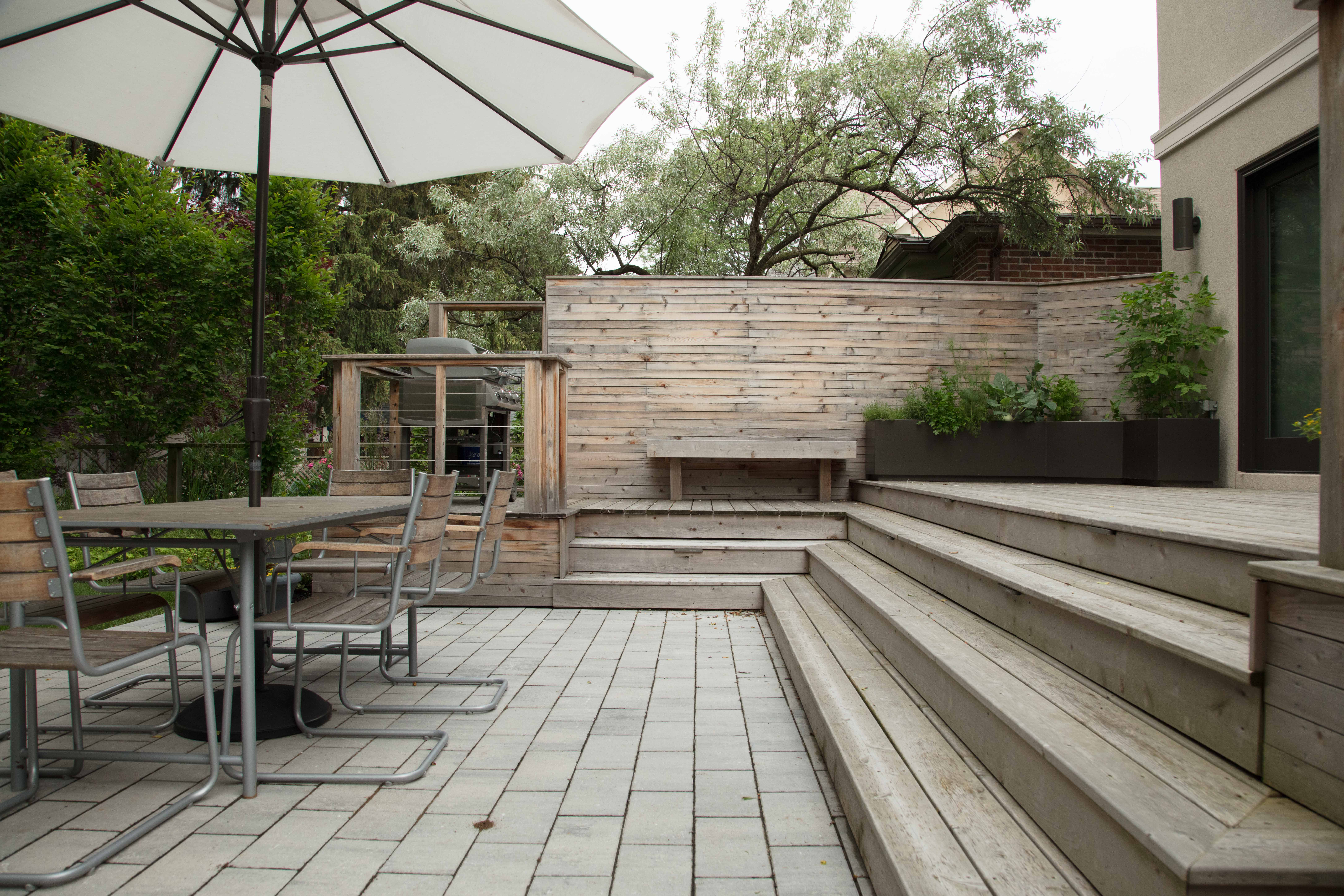 Backyard patio and deck with outdoor cooking and dining area