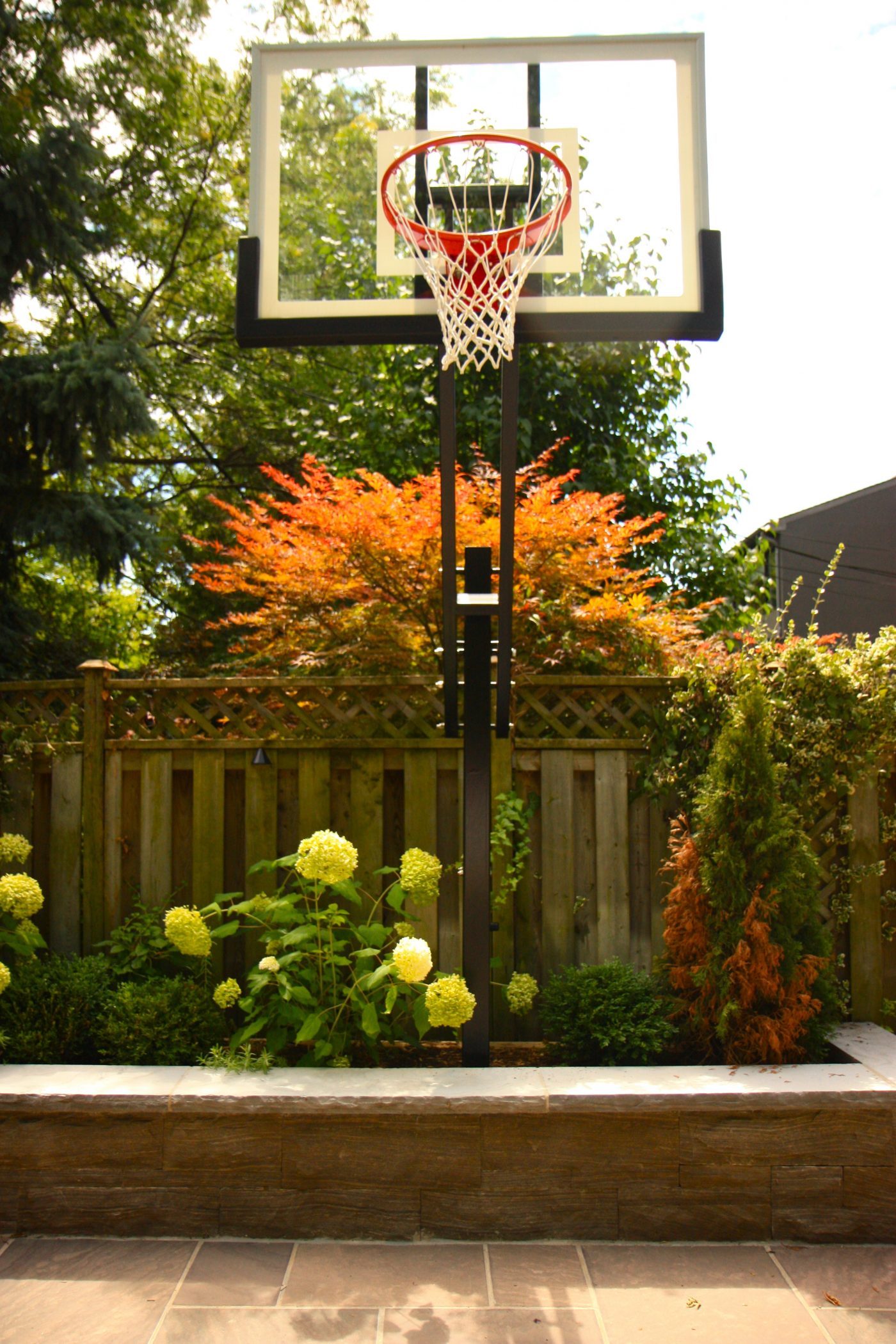 Basketball net surrounded by retaining wall garden beds