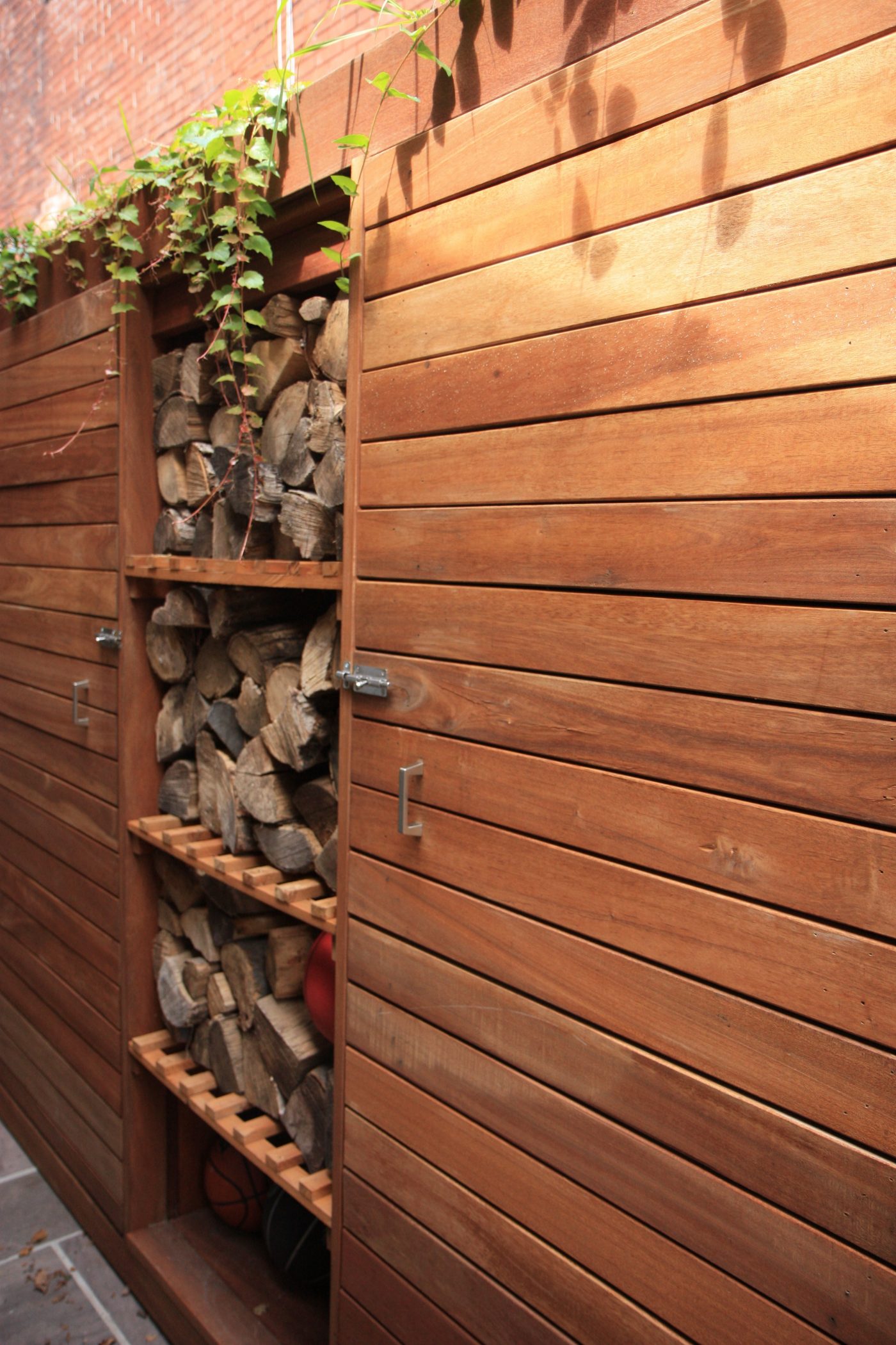 Fence with built in fire wood storage