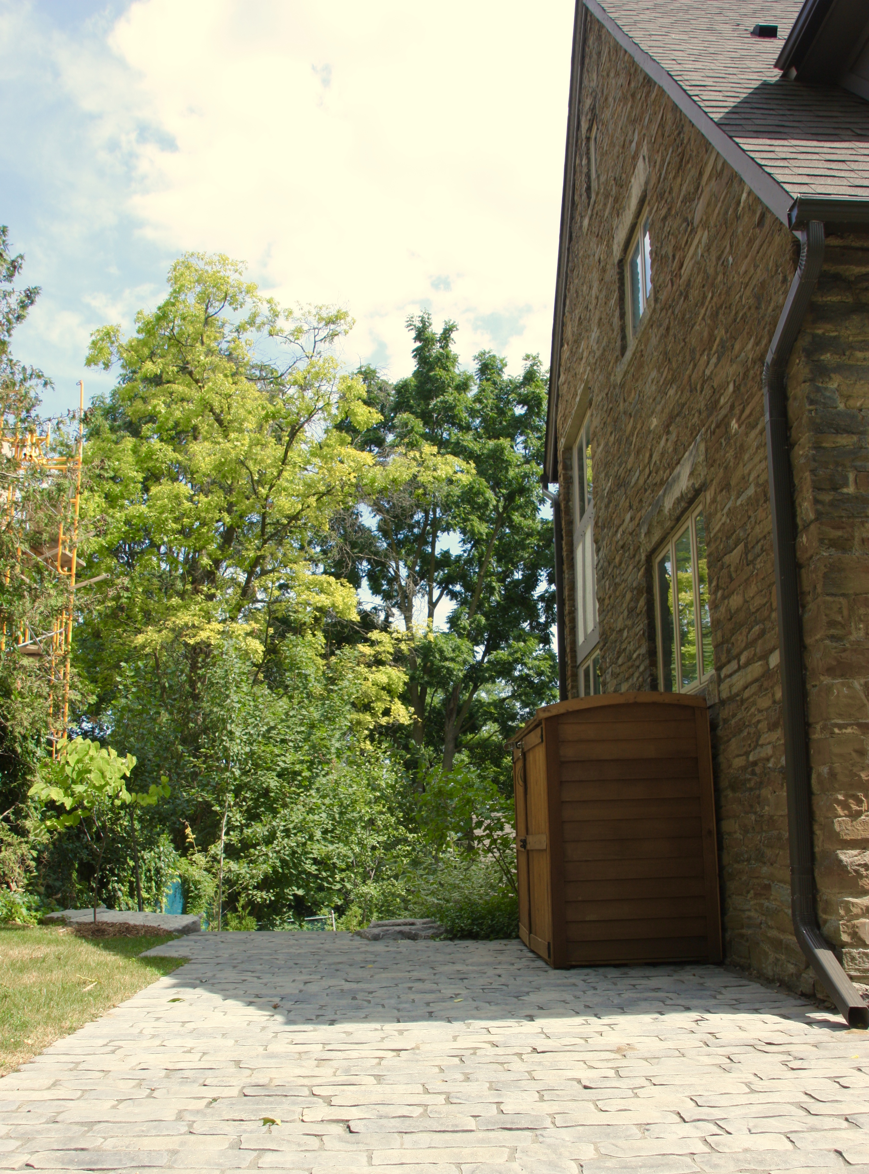 Side of house storage on top of outdoor stone patio
