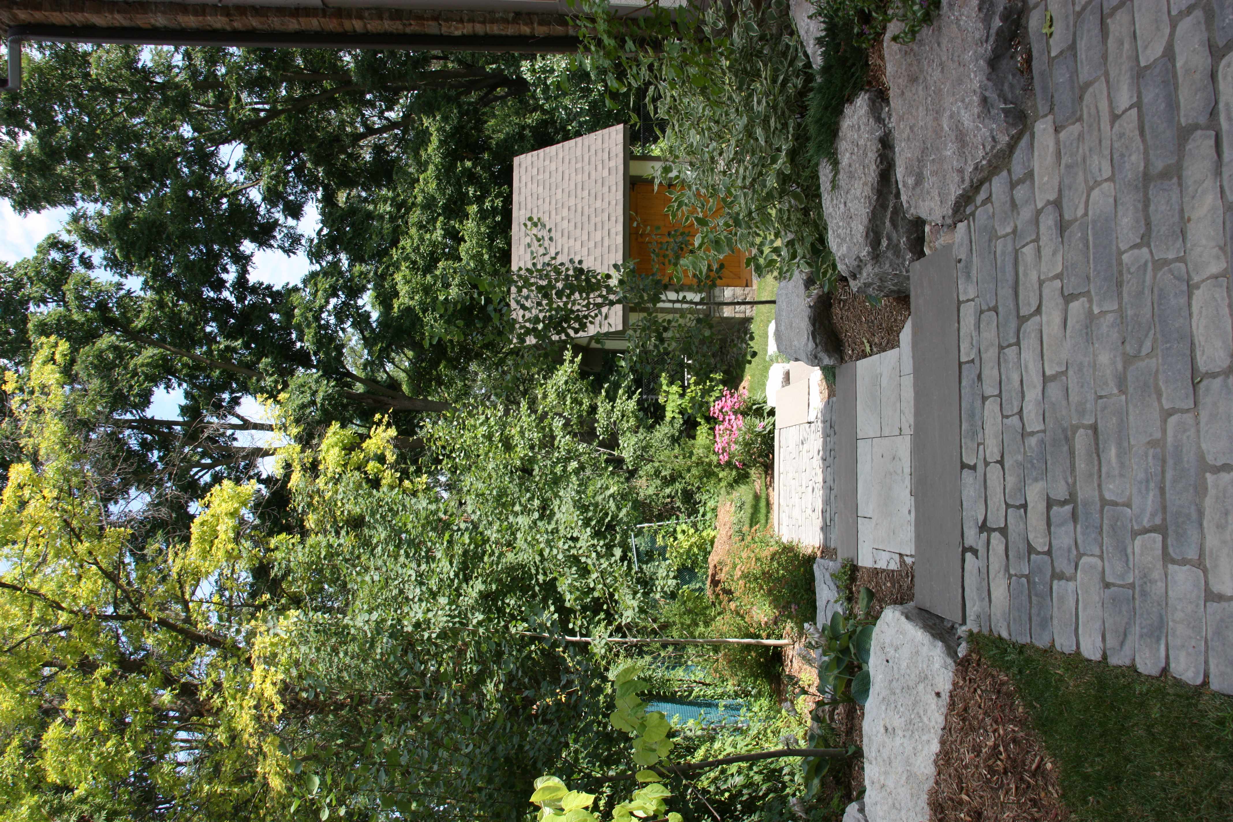 custom built interlock stone steps leading to backyard lawn