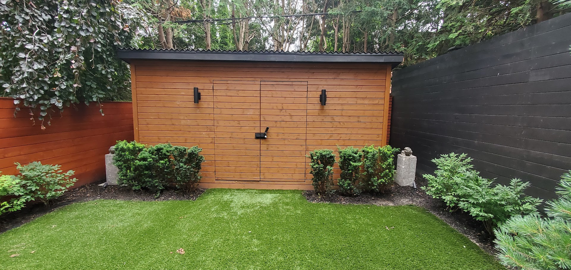 Lawn Space with intricate hedges and custom built shed