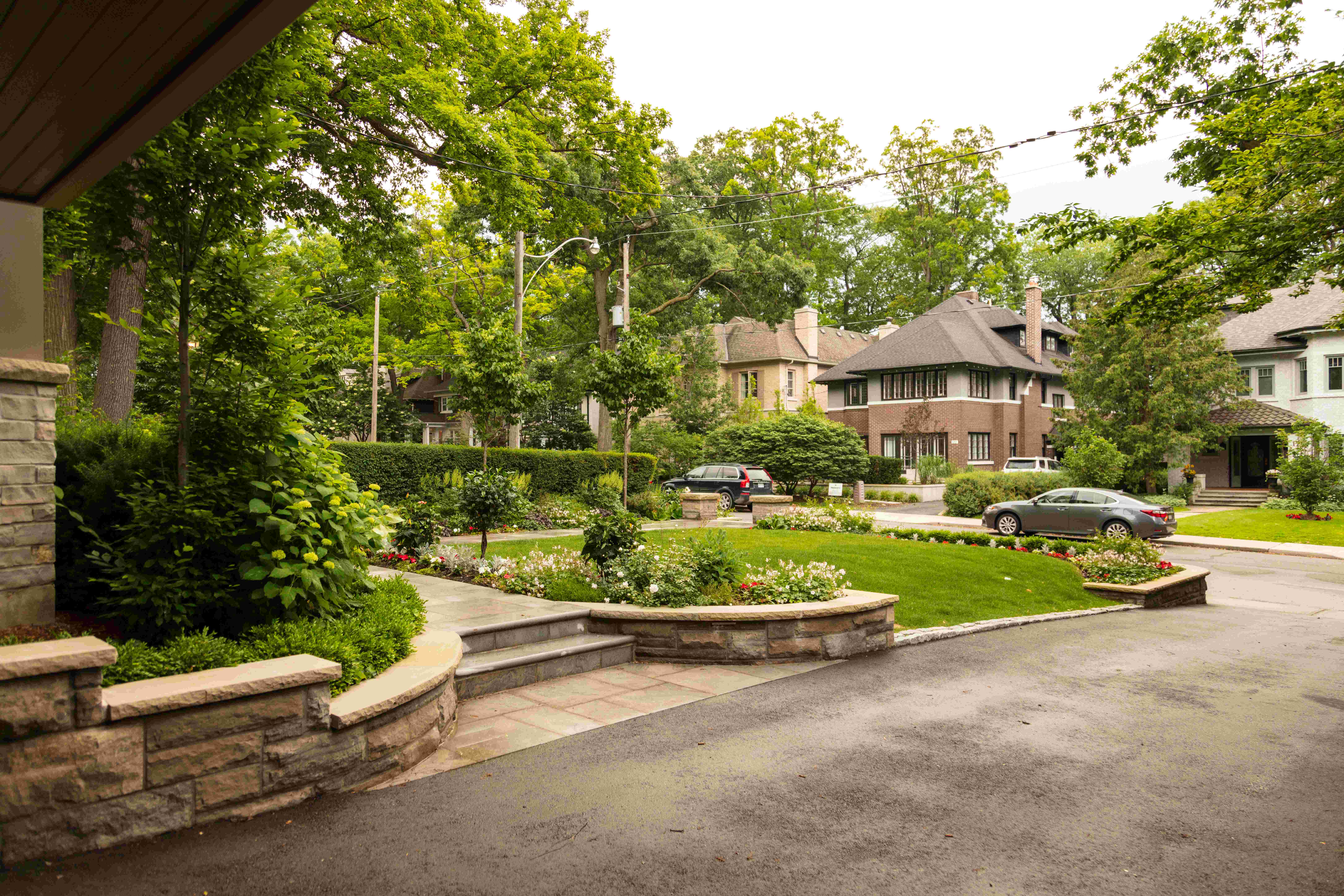 Property street view showing stone walkway and garden beds