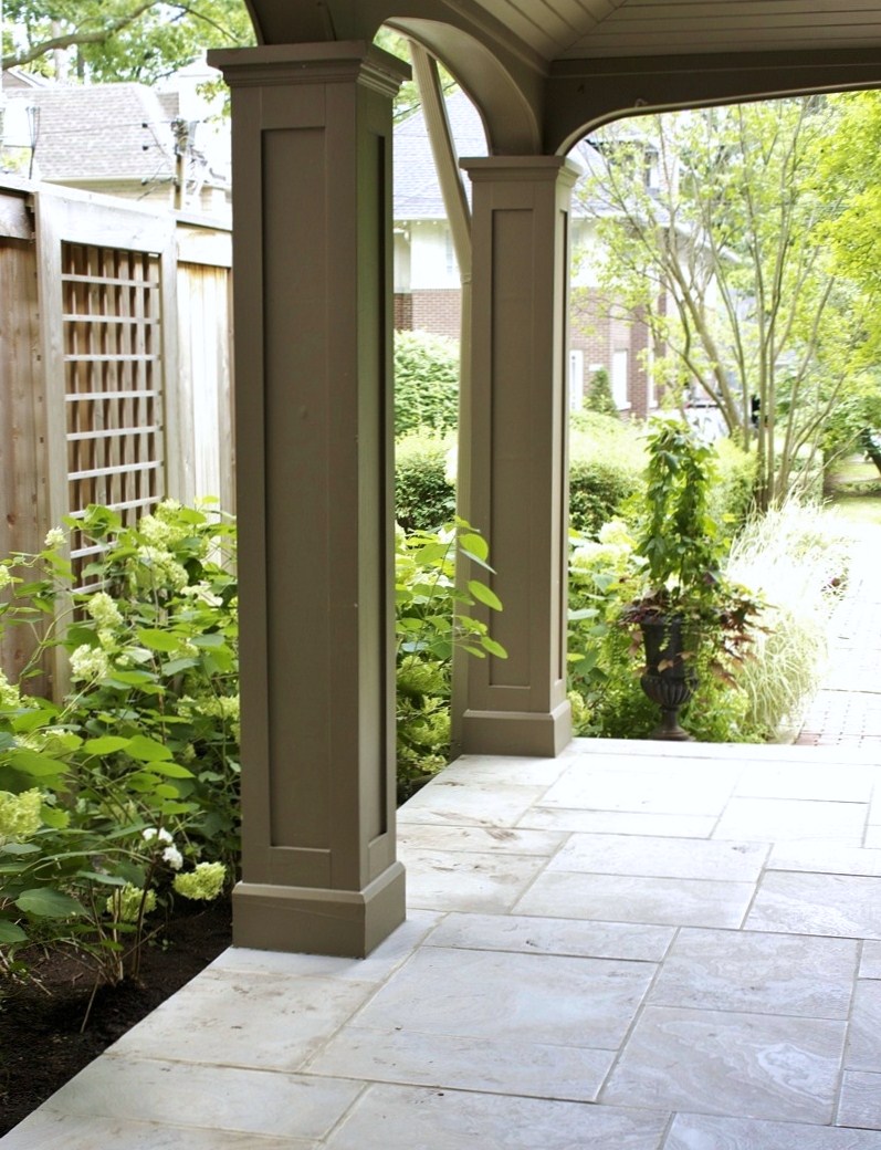 Stone pavers under backyard overhang pergola