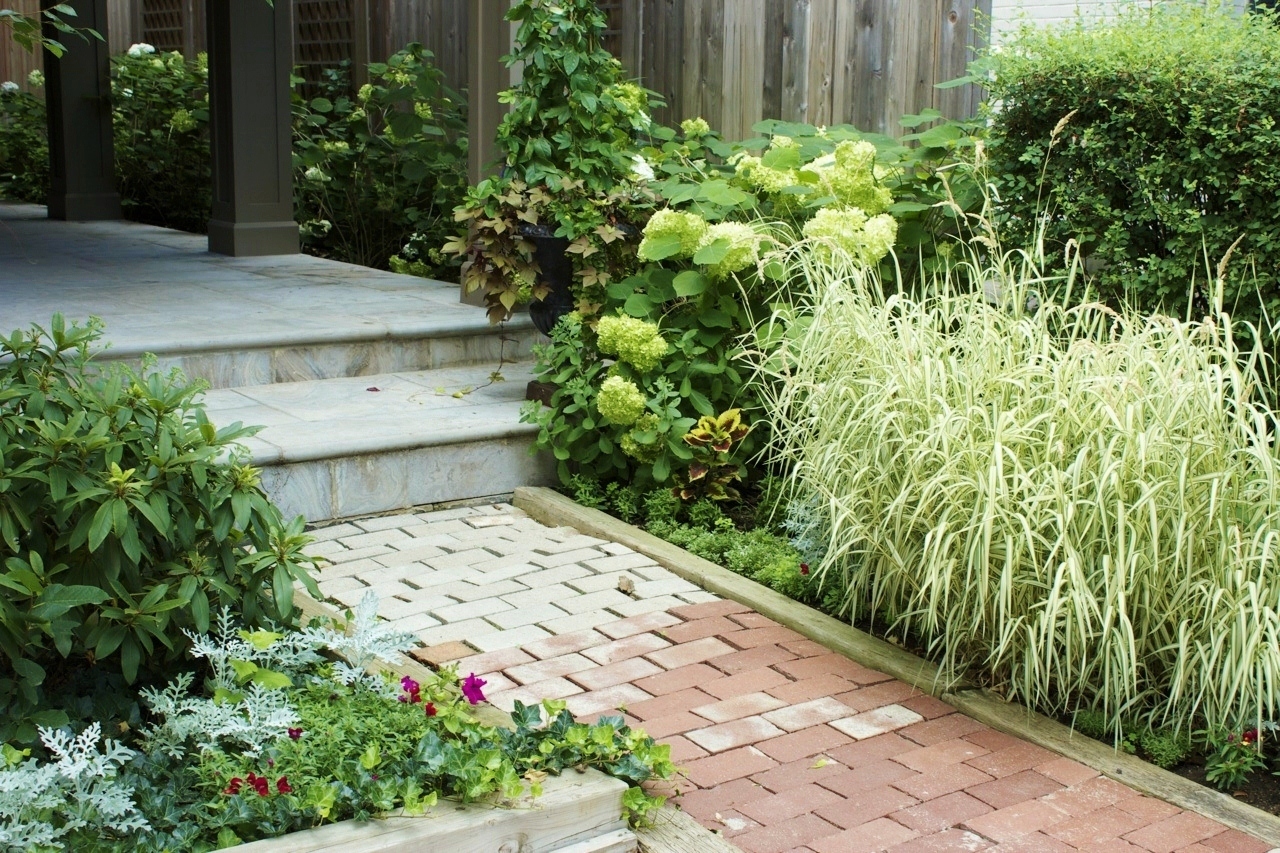 Front Entrance stone walkway built around grass gardens