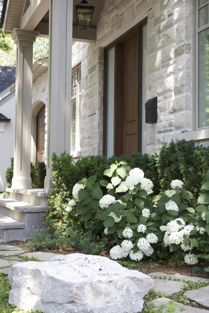 White flower hydrangeas with natural stone barrier