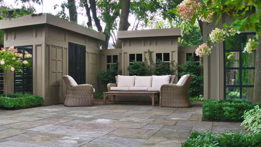 Stone patio with surrounding furniture built into outdoor spaces and buildings
