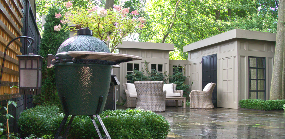 wet stone, box woods and a canopy over an outdoor space