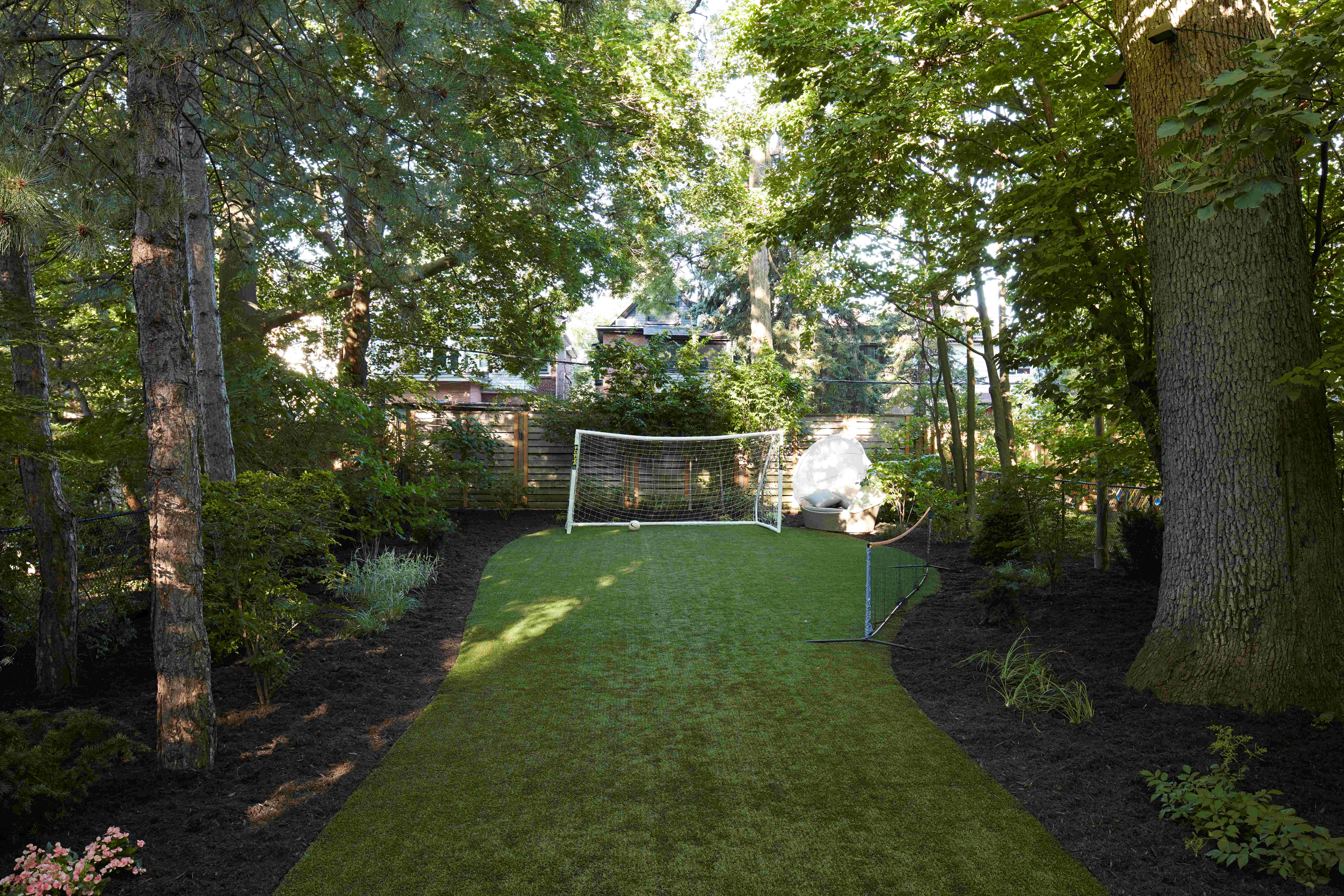 Outdoor lawn space with mulching on the side showcasing outdoor soccer space