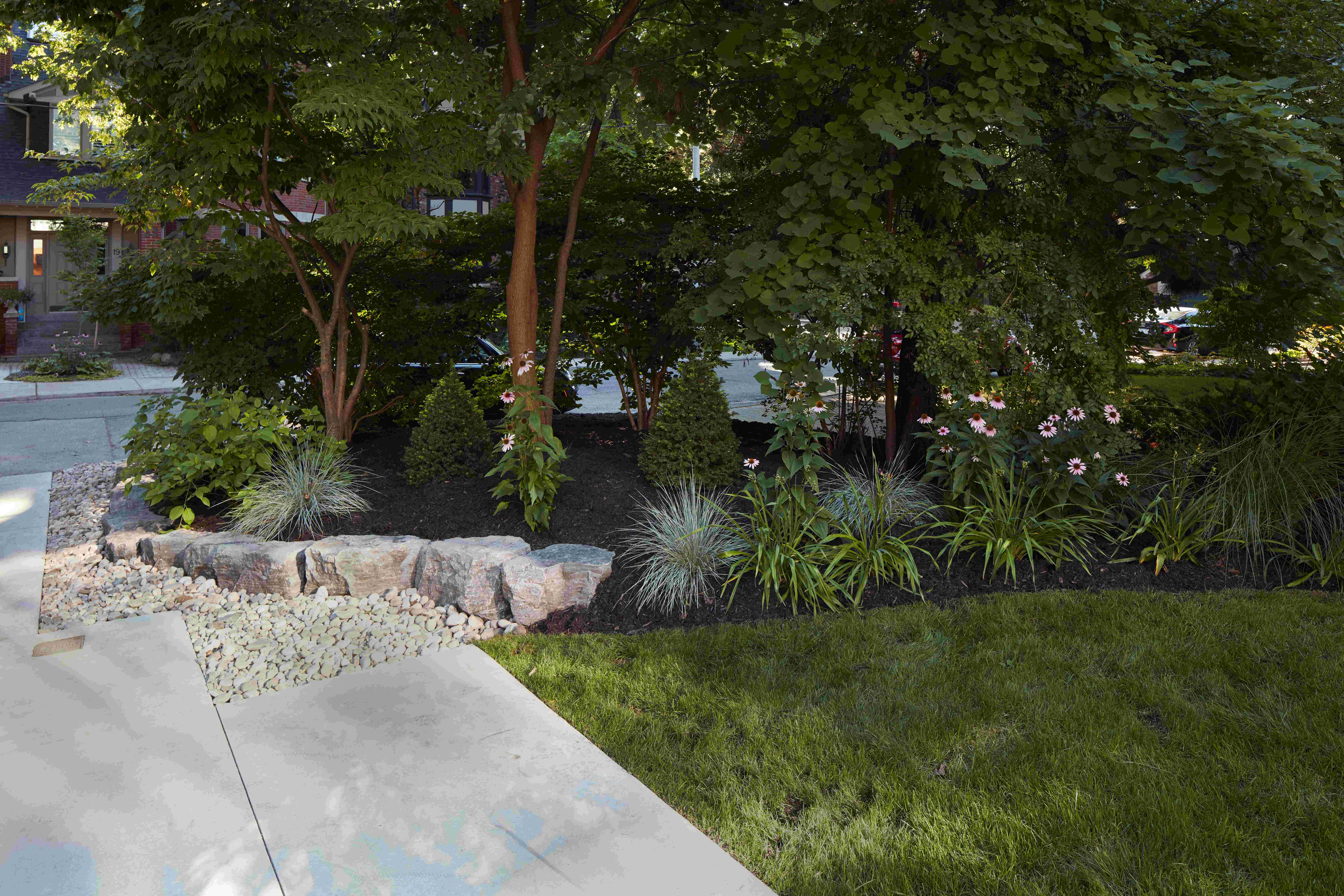 Front driveway with garden bed running along the side with black mulch