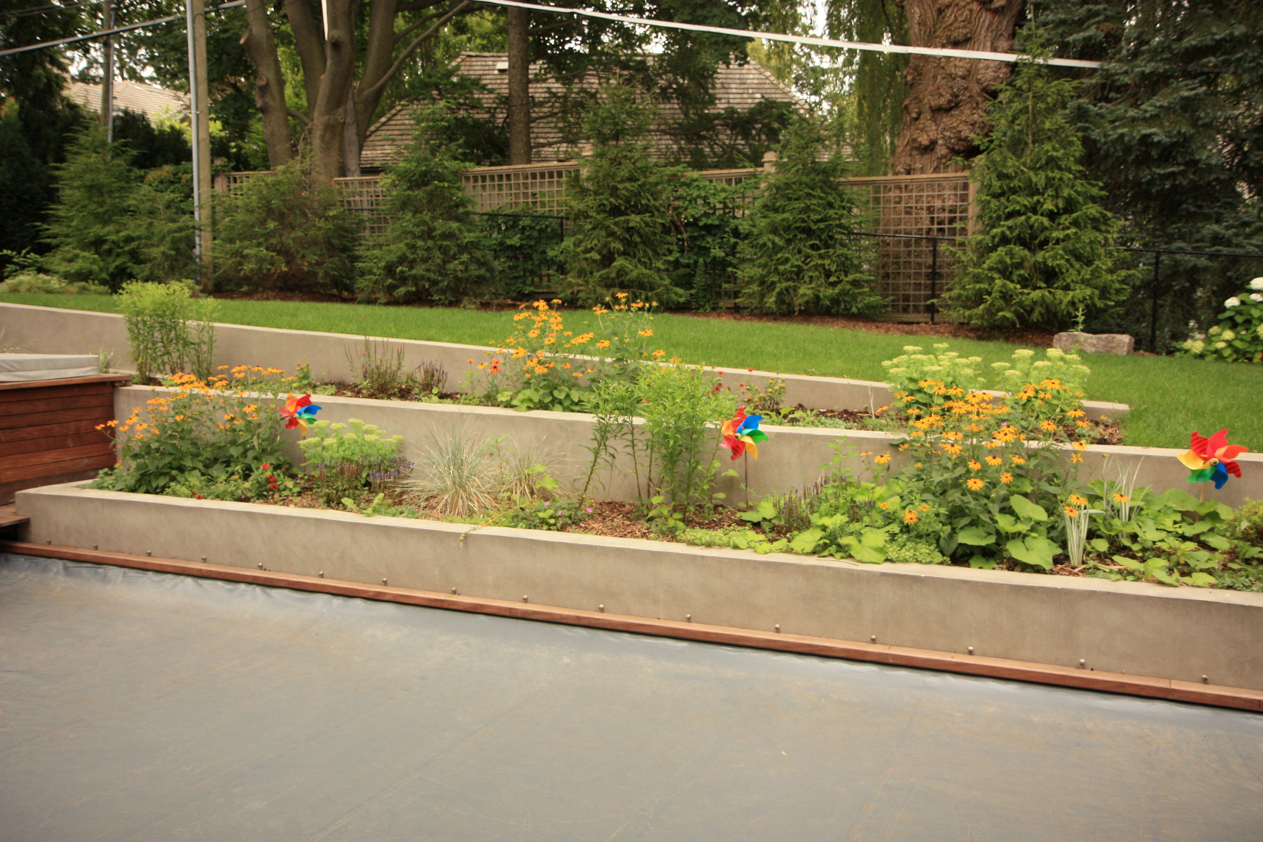 retaining walls containing tall grasses and playful pinwheels