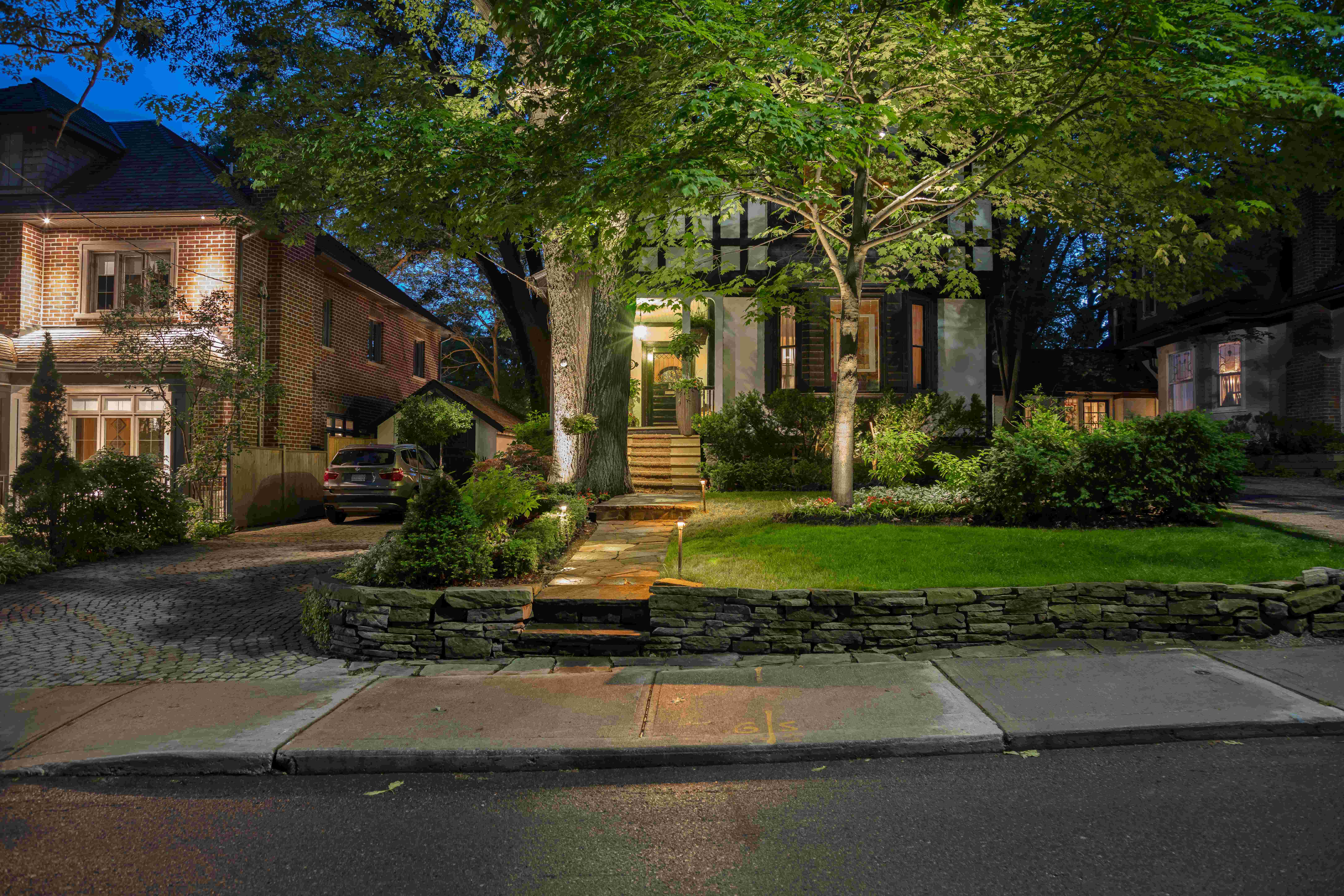 Cobble stone wall keeps lawn in place in front of this traditional home