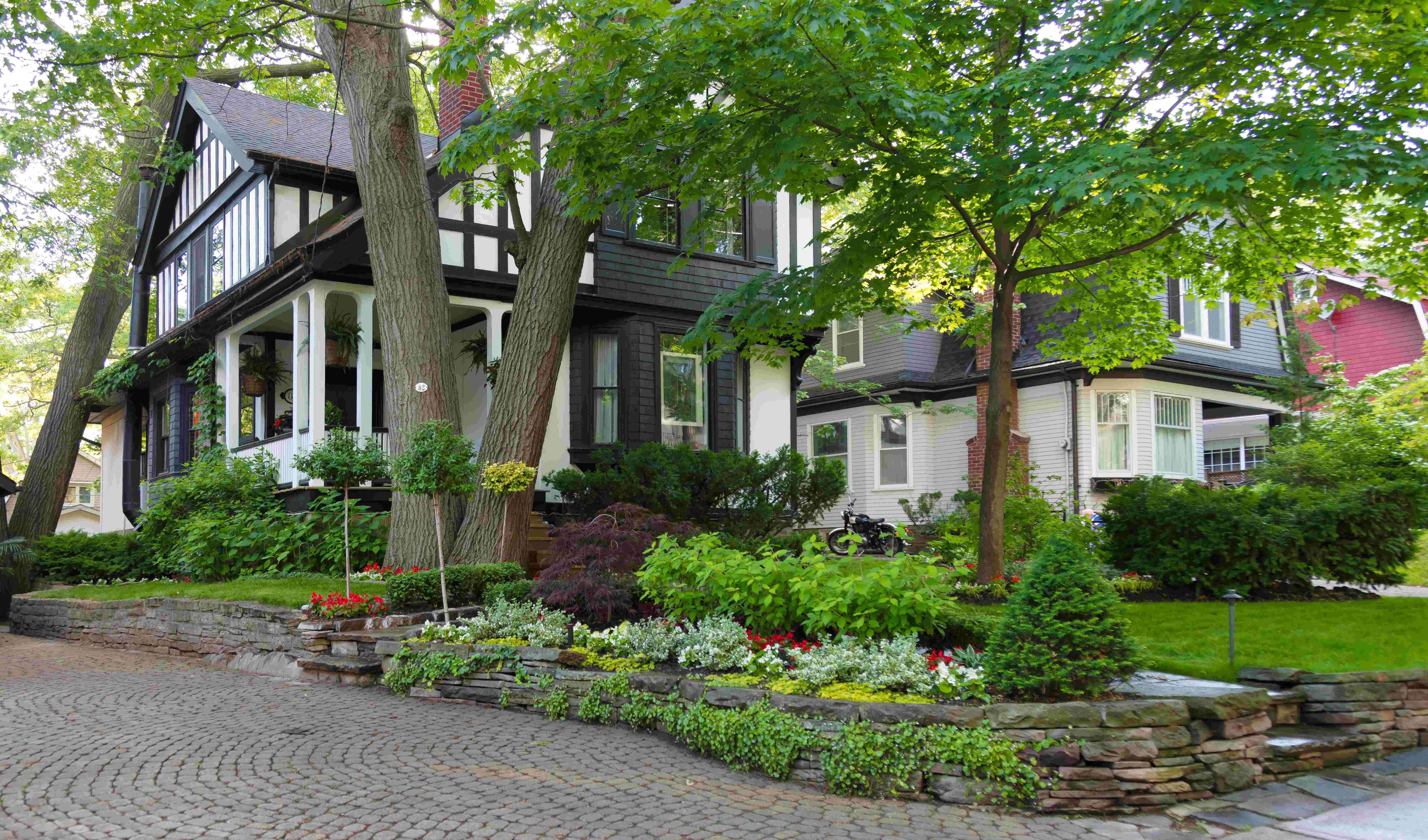 Full property view showcasing the beauty of the garden beds nestled between the trees