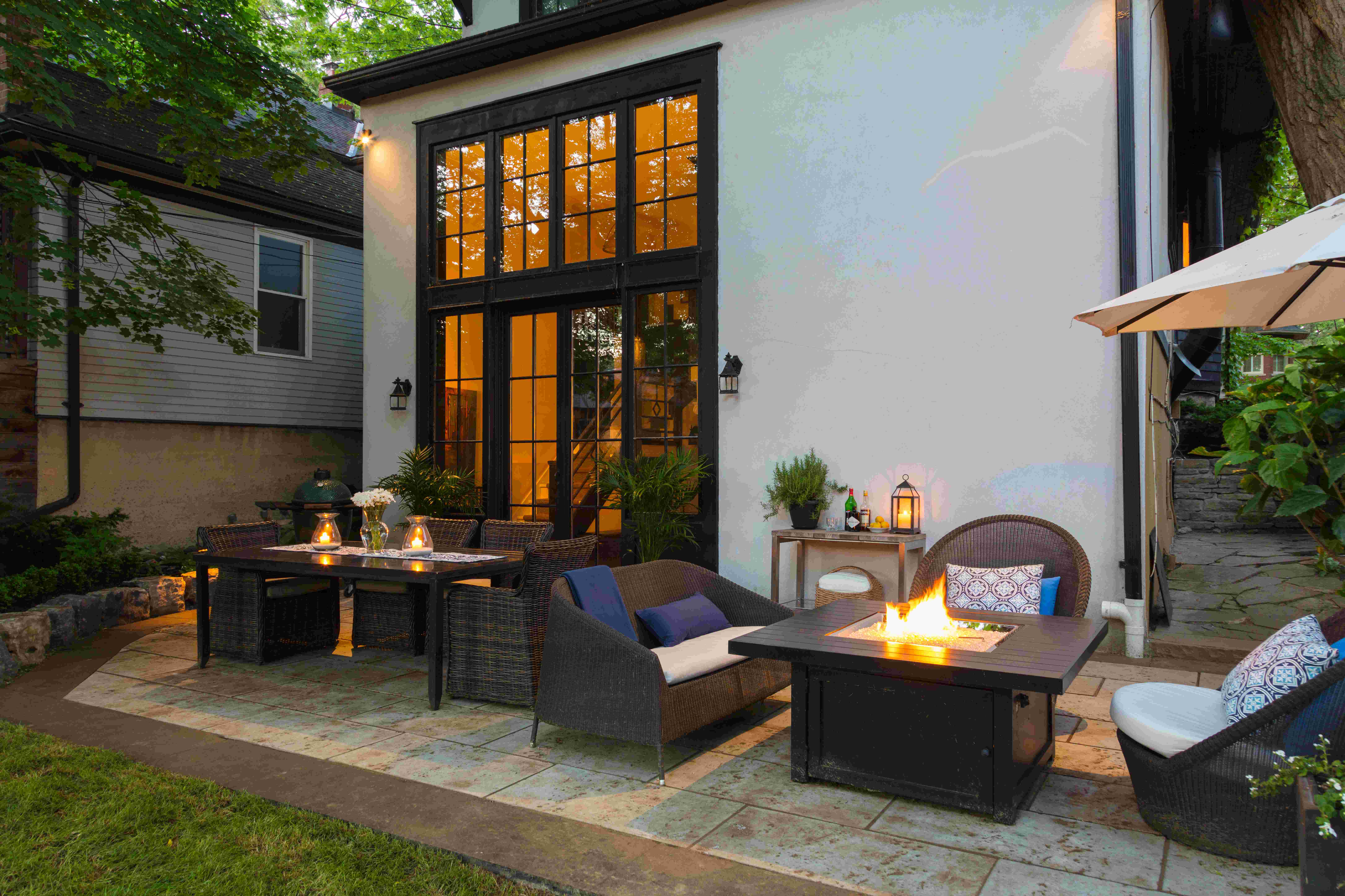 backyard dining and sitting spot on stone patio