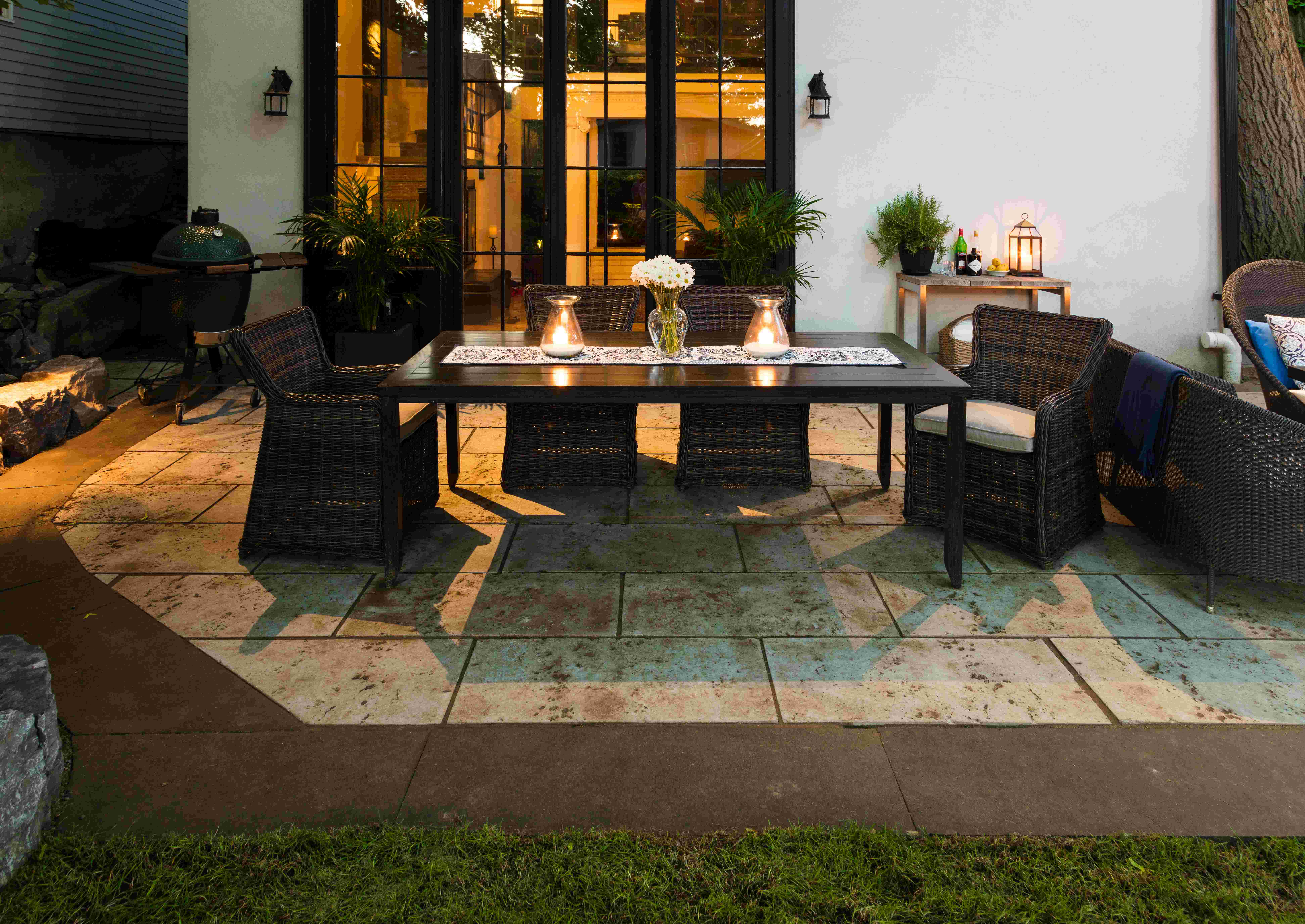 custom built stone patio containing outdoor dining table and charis