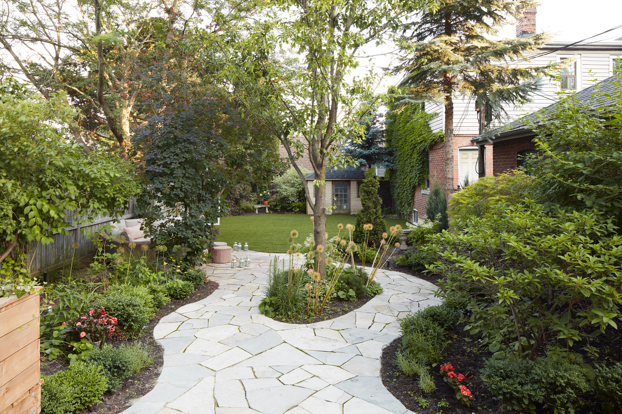 Stone layed around existing garden beds and trees creating unique shapes