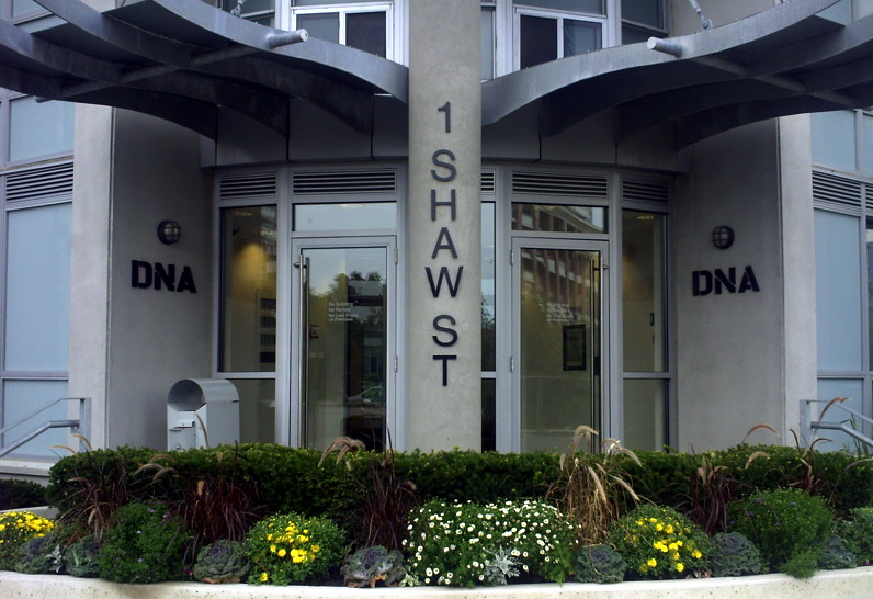 Entrance to building with annuals in front of hedge