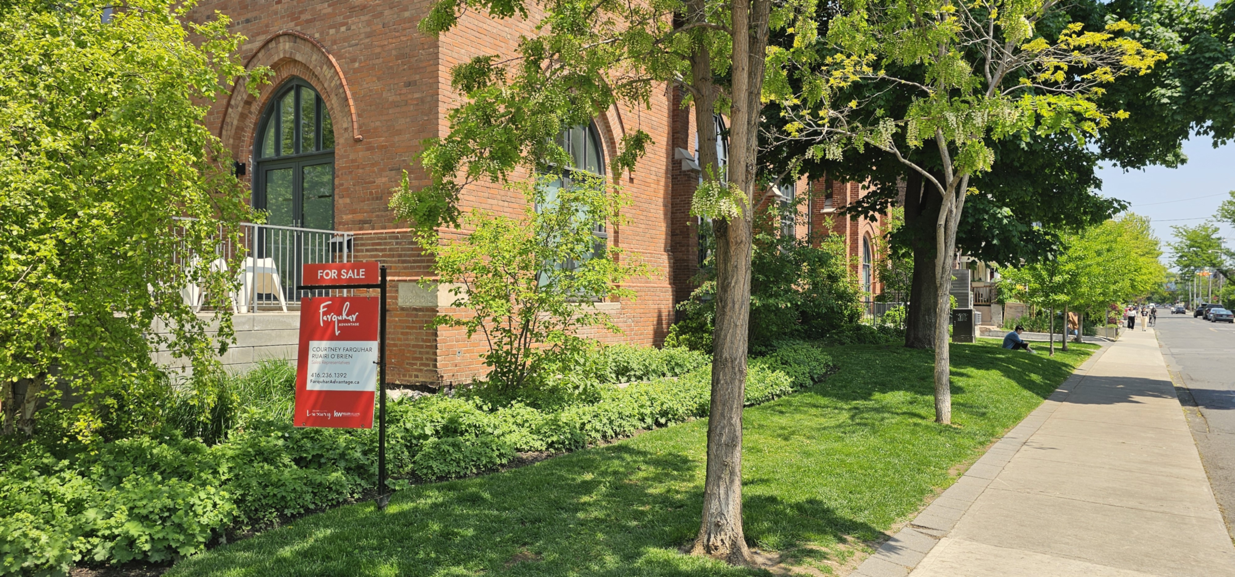 Corner view of property showcasing the curb appeal of summer maintenance work