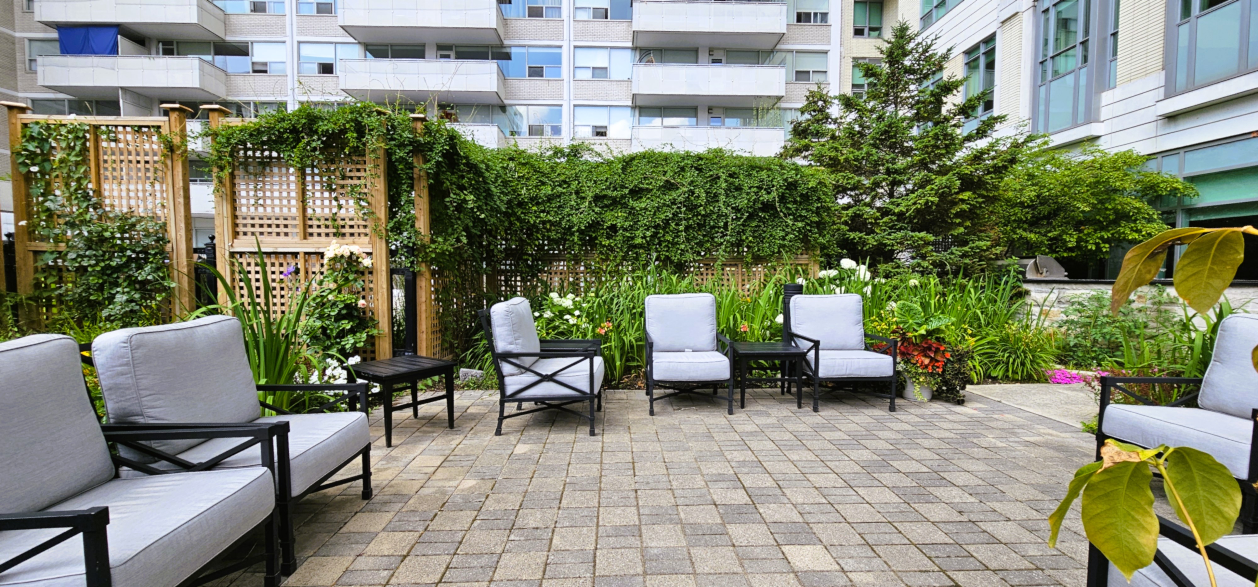 Outdoor seating area with stone pavers and lawn chairs