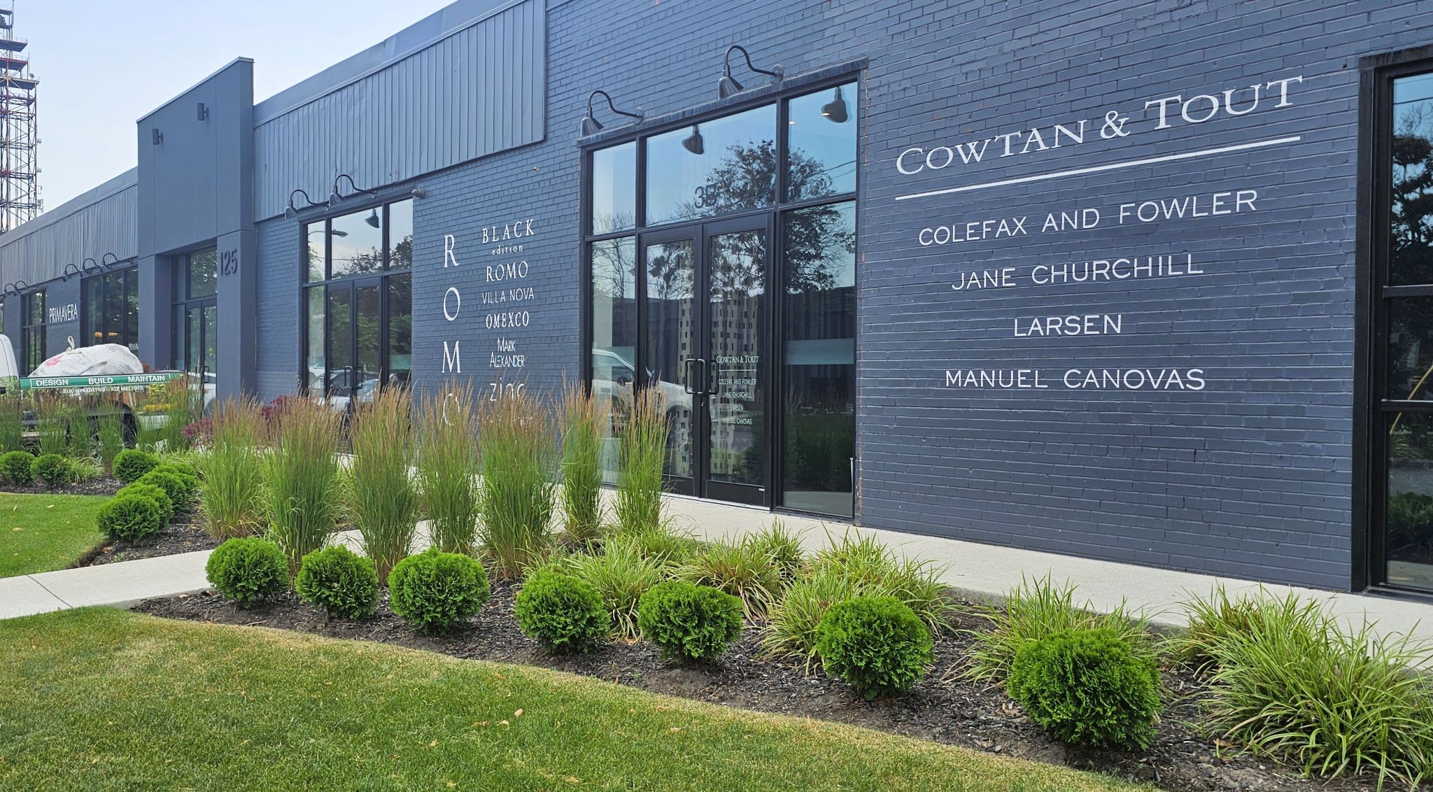 Ornamental grass entrance with shrubs